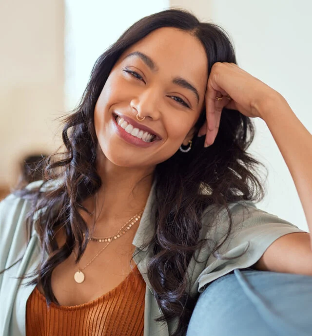 Smiling woman seated on a couch